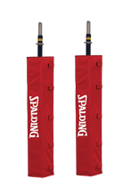 Pair of red Spalding volleyball upright pads on a white background