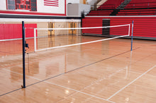 Indoor slide multi-court system with red bleachers and American flag in the background.
