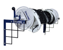 Showing how the net winder fits on the top of the wall mount to store volleyball nets.